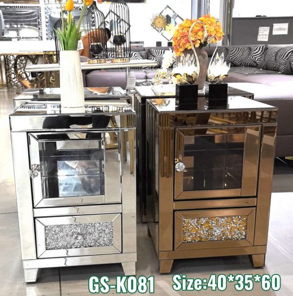 Compact mirrored bedside table with a crystal handle, storage drawer, and crushed glass detail — available in gold or silver.